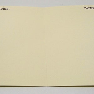 May include: A blank, off-white card with the word "Notes" printed in black at the top of each side.