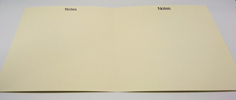 May include: A blank, off-white card with the word "Notes" printed in black at the top of each side.