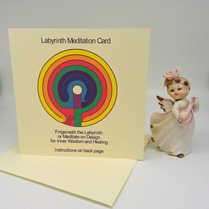 May include: A yellow card with a rainbow colored labyrinth design. The text "Labyrinth Meditation Card" is at the top of the card. The text "Fingerwalk the Labyrinth or Meditate on Design for Inner Wisdom and Healing" is below the labyrinth. The text "Instructions on back page" is at the bottom of the card.