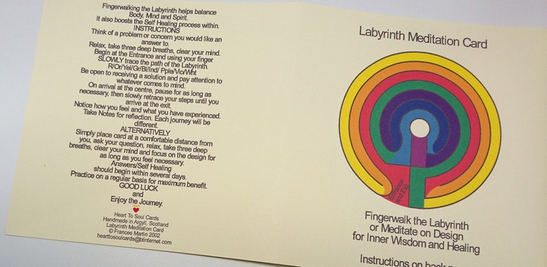 May include: A yellow card with instructions on how to use a labyrinth for meditation. The card features a colorful labyrinth design with a white center and a red heart symbol in the bottom left corner. The text on the card reads "Labyrinth Meditation Card" and "Fingerwalk the Labyrinth or Meditate on Design for Inner Wisdom and Healing".