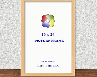 May include: A rectangular picture frame made of light-colored wood. The frame holds a white background with the text "16 x 24 PICTURE FRAME." The frame is made in the U.S.A. and is real wood. A colorful logo is at the top.