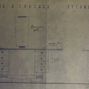 May include: Architectural blueprint of a bedroom set, featuring a desk with drawers and a tall, cylindrical object on top. The drawing is labeled "CHAMBRE A COUCHER SYCOMORE VERNI" in capital letters, with handwritten notes and measurements.