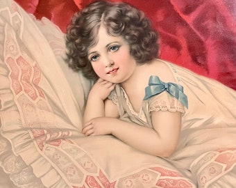 1890s French Chromolithograph on paper. Reclining child with curly hair.Little girl in bed.