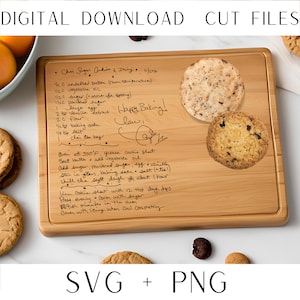 May include: A wooden cutting board with handwritten instructions for making chai sugar cookies. The recipe includes ingredients like unsalted butter, vegetable oil, sugar, flour, vanilla extract, baking soda, and salt. The board has a light brown color and is decorated with two cookies.