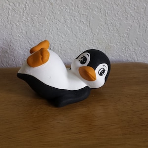 Ceramic Playful Penguin laying on Back (#48E)