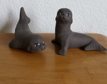 Ceramic Seals - 1 with head up and 1 laying on Belly (#699A)