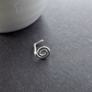 May include: Silver nose ring with a spiral design.