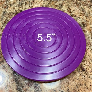 May include: Purple 5.5 inch mini turntable with concentric circles.