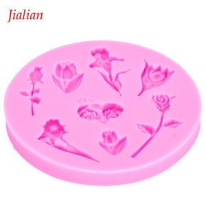 May include: Pink silicone mold with eight different flower designs, including roses, tulips, and a butterfly.