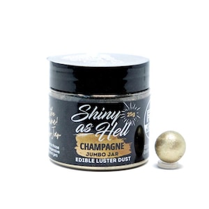 May include: A small jar of edible gold luster dust labeled "Shiny as Hell Champagne Jumbo Jar 25g Edible Luster Dust". A small gold ball of luster dust is shown next to the jar.