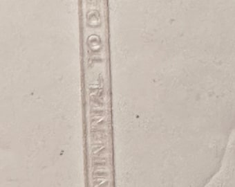 May include: Clear plastic cocktail pick with a decorative figure at the top and the text "CONTINENTAL MEXICO" printed vertically. The pick has a pointed end.