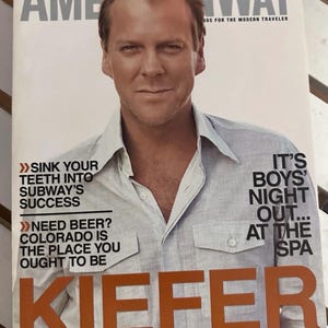 May include: A magazine cover with actor Kiefer Sutherland. The magazine is titled "American Way" with the American Airlines logo. Text includes "Sink your teeth into Subway's success" and "It's Boys' Night Out... at the Spa."