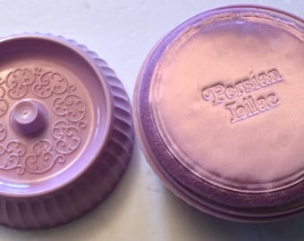 May include: Two-piece, light purple, vintage kitchenware. One piece is a round, fluted bowl with an ornate, raised floral design in the center. The other piece is a lid with the words "Persian Lilac" embossed on the top.