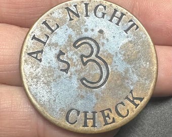 May include: A circular brass-toned metal token with a weathered, mottled surface. The text "ALL NIGHT" is arched across the top, "CHECK" is arched across the bottom, and a large "$3" is engraved in the center with black lettering.