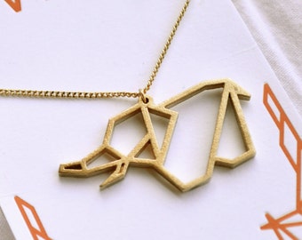 May include: Gold origami elephant necklace with a delicate chain. The necklace is displayed on a white card with the word "WOW" and the website "wowwearables.etsy.com".