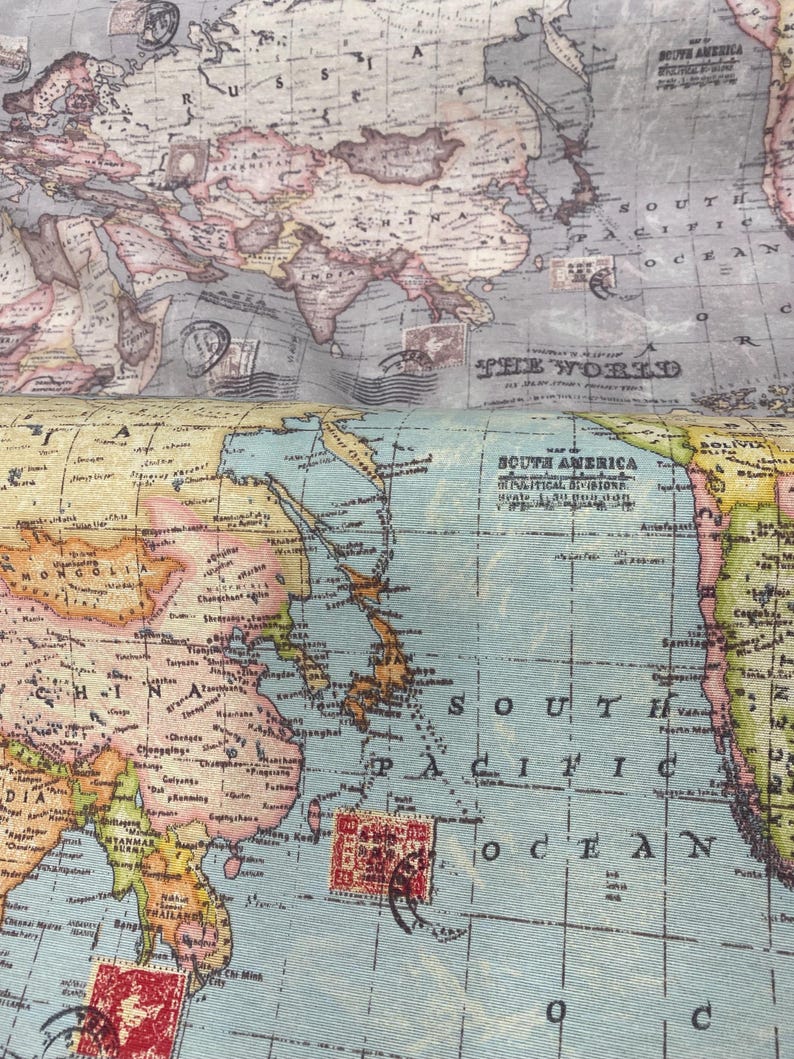 May include: A vintage world map with a blue and green color scheme. The map shows the continents of Asia, Australia, and South America. The map is printed on a textured fabric.