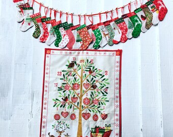 May include: A fabric advent calendar wall hanging featuring a printed tree with numbered pockets, surrounded by a red border. Above it, twenty-four miniature Christmas stockings in various red, green, and white patterns hang from a red ribbon.