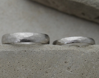 Sustainably recycled platinum wedding rings with a hammered surface
