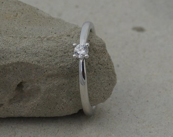 Delicate engagement ring with diamond