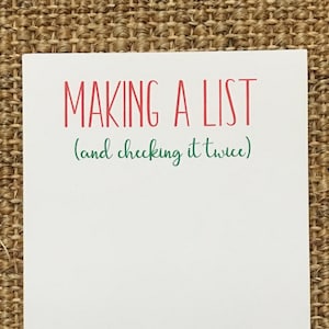 May include: White notepad with red and green text that reads "MAKING A LIST (and checking it twice)"
