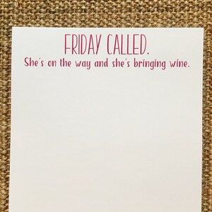 May include: White card with pink text that reads "FRIDAY CALLED. She's on the way and she's bringing wine."