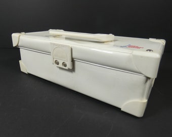 May include: White metal storage box with a carrying handle and a latch. The box has a red and blue logo that says "Super Star Trading Co."