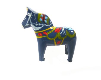 May include: A blue wooden Dala horse with yellow, red, green, and white painted details. The horse is a traditional Swedish folk art object.