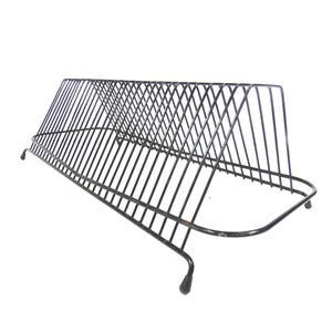 May include: Black metal record holder with a slanted design. The holder features multiple vertical bars to separate and display vinyl records. The base has a curved design with small feet for stability. A vintage-style storage solution.