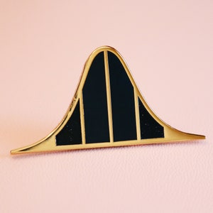 Puede incluir: Pin de metal dorado en forma de curva de campana con tres rayas negras.