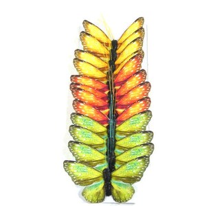 May include: A stack of 15 colorful paper butterflies in shades of yellow, orange, and green. The butterflies are arranged in a vertical stack, with the yellow butterflies at the top and the green butterflies at the bottom.