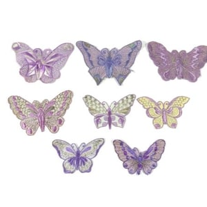 Puede incluir: Surtido de nueve parches de mariposa de hierro en color morado y plateado. Las mariposas son de varios tamaños y tienen diferentes patrones.