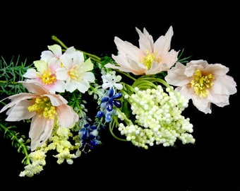 May include: A bouquet of pink and white flowers with green leaves and white berries. The flowers have a delicate, feminine look.