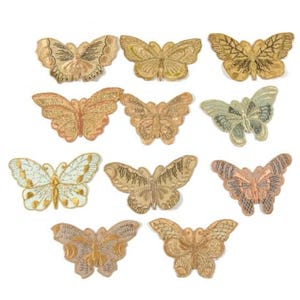 May include: Twelve embroidered butterfly patches in various shades of gold, peach, and white. The butterflies have intricate details and are perfect for adding a touch of whimsy to clothing, bags, or home decor.