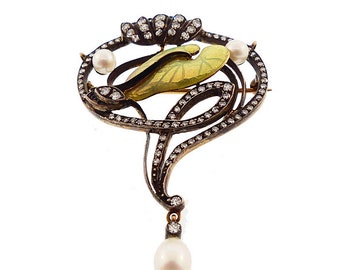 May include: A gold and silver Art Nouveau brooch with a green enamel flower design, set with diamonds and pearls.