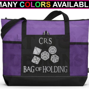 May include: Purple tote bag with a black zippered pocket and mesh side pockets. The pocket has a design of dice and the text "CRS BAG OF HOLDING".