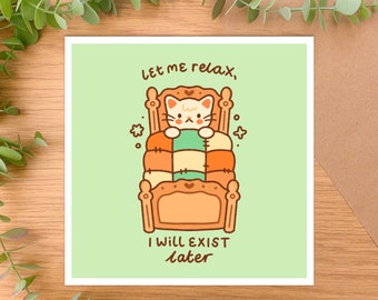 May include: A green card with a white cat in a bed with a brown headboard and a multi-colored quilt. The text on the card reads "Let me relax, I will exist later."