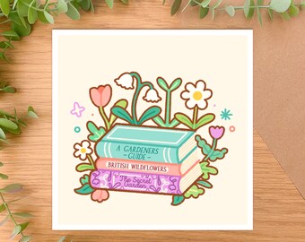 May include: A stack of three books with floral illustrations. The top book is teal and says "A Gardeners Guide". The middle book is pink and says "British Wildflowers". The bottom book is purple and says "The Secret Garden".