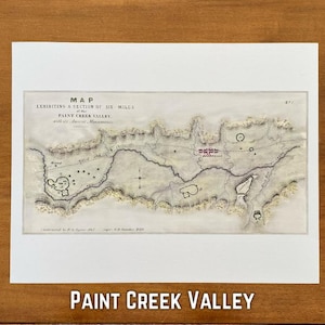 May include: A detailed map of the Paint Creek Valley, showcasing a section of six miles with ancient monuments. The map is in sepia tones, with text at the top and bottom. The title "Paint Creek Valley" is displayed in bold, white letters at the bottom.