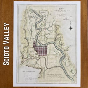 May include: An antique map of the Scioto Valley, featuring a detailed illustration of the ancient monuments. The map, constructed by E.G. Squier in 1847, includes a compass rose and text. The map is printed on aged paper with a white border.