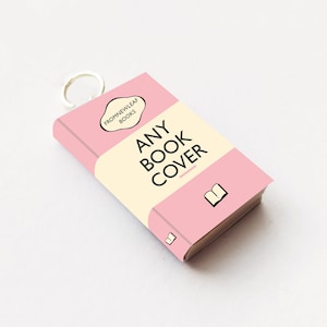 May include: A pink book cover with the text "ANY BOOK COVER" and a small book icon. The book cover has a white speech bubble with the text "FromNewLeaf Books".