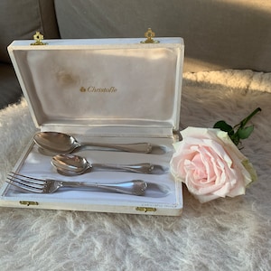 Christofle Rubans Croises silver plated antique children's cutlery with monograms in original box.