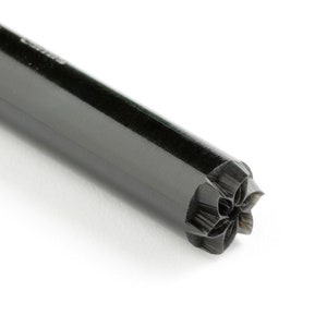 May include: Black metal stamp with a flower design. The stamp is cylindrical and has a black handle.