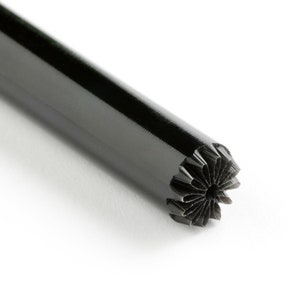 May include: A black metal punch tool with a star-shaped design on the end.
