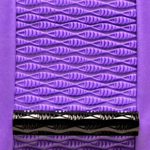 May include: Purple silicone rolling pin with a black and silver patterned roller. The silicone surface has a repeating pattern of fish.