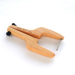 May include: A wooden tool with a metal pin, labelled "MKM RH-2 China".
