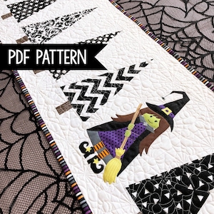 May include: A white quilted Halloween table runner featuring black and white patterned trees and a cartoon witch on a broom. The text "PDF PATTERN" is displayed on a black banner.