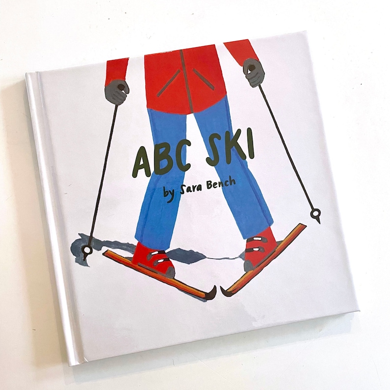 May include: A children's book cover with a colorful illustration of a person skiing. The title of the book is "ABC Ski" by Sara Bench.