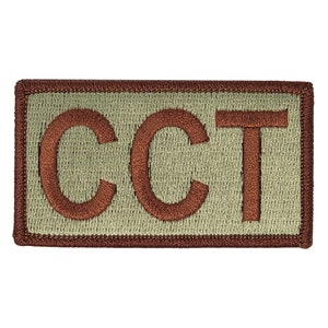 May include: A brown embroidered patch with the letters "CCT" in a beige rectangle.