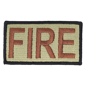May include: A rectangular patch with the word "FIRE" embroidered in brown thread. The patch has a tan background with a black border.