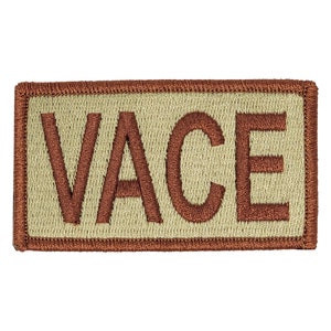 May include: A tan embroidered patch with the word "VACE" in brown thread.